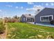 Expansive backyard with lush lawn, mature trees, and a charming patio area perfect for outdoor entertaining at 1995 Xenia St, Denver, CO 80220