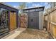 Backyard shed featuring dark gray vertical siding and a side patio space at 1995 Xenia St, Denver, CO 80220