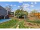 Large backyard with grassy area, bordered by a metal fence and chain link to the back section at 1995 Xenia St, Denver, CO 80220