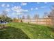 Spacious backyard with green lawn and surrounding wood fence at 1995 Xenia St, Denver, CO 80220