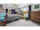 Serene bedroom with ample natural light, complemented by a comfortable bed, stylish dressers, and a ceiling fan at 1995 Xenia St, Denver, CO 80220