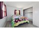 Bedroom featuring large quilted bed, two windows, and ample closet space at 1995 Xenia St, Denver, CO 80220
