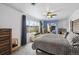 Bright bedroom featuring a soft gray comforter, a ceiling fan, and a window with natural light at 1995 Xenia St, Denver, CO 80220