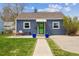 Charming blue home with a well-manicured lawn, bright green door and cozy front porch at 1995 Xenia St, Denver, CO 80220