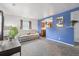 Bright living room with a comfortable couch, view of the kitchen and large windows at 1995 Xenia St, Denver, CO 80220