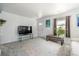 Living room featuring a large TV, neutral walls and carpet, and natural light at 1995 Xenia St, Denver, CO 80220