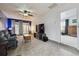 Bright living room with modern lighting, sliding glass door and neutral carpet creating a relaxing space at 1995 Xenia St, Denver, CO 80220
