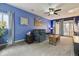Cozy living room featuring a comfortable sofa, ceiling fan, and sliding doors leading to the backyard, perfect for relaxation at 1995 Xenia St, Denver, CO 80220