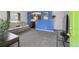 Cozy living room with gray carpet, blue accent wall, and open view to the kitchen at 1995 Xenia St, Denver, CO 80220