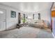 Well-lit living room featuring a plush couch, neutral decor, and natural light at 1995 Xenia St, Denver, CO 80220