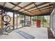 Sunroom with exposed beams and multipurpose space with storage for bikes and tools at 1995 Xenia St, Denver, CO 80220