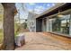 Relaxing outdoor patio area, enhanced by a large tree for shade and privacy next to the home's exterior at 1995 Xenia St, Denver, CO 80220