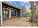 Charming backyard patio area with stone flooring, complemented by a tree and a partial view of the house's exterior at 1995 Xenia St, Denver, CO 80220