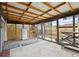 Sunroom with exposed beams and multipurpose space with storage for bikes and tools at 1995 Xenia St, Denver, CO 80220