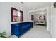 Bright room with plush blue velvet couch connected to a sleeping space and large windows at 1995 Xenia St, Denver, CO 80220