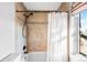 Tiled bath and shower with updated black fixtures and a window to the outside at 451 W 152Nd Ave, Broomfield, CO 80023