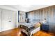 Bedroom with rustic wood accent wall, hardwood floors, and natural light at 451 W 152Nd Ave, Broomfield, CO 80023