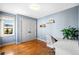 Bright bedroom with hardwood floors, blue walls, and a modern white desk at 451 W 152Nd Ave, Broomfield, CO 80023