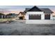 Modern farmhouse with a large garage, a well-kept lawn, and an inviting walkway at 451 W 152Nd Ave, Broomfield, CO 80023