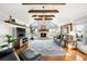 Spacious living room with high ceilings, wooden beams, and a stone fireplace, creating a cozy and inviting atmosphere at 451 W 152Nd Ave, Broomfield, CO 80023