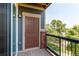 Inviting balcony features a door, brick pillar, and black metal handrail at 804 Summer Hawk Dr # 3202, Longmont, CO 80504