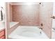 A full tub surrounded by earth-toned tile at 804 Summer Hawk Dr # 3202, Longmont, CO 80504