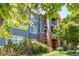 Charming multi-level condo building with brick accents, balconies, and lush green landscaping at 804 Summer Hawk Dr # 3202, Longmont, CO 80504