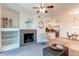 Open-concept living room with a fireplace, built-in shelving, and a view of the kitchen and dining area at 804 Summer Hawk Dr # 3202, Longmont, CO 80504