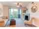 Living room with a fireplace, comfortable seating, and large sliding glass doors to the outside balcony at 804 Summer Hawk Dr # 3202, Longmont, CO 80504