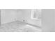 Clean and bright basement with marble-tiled floors and window at 524 Rider Ridge Dr, Longmont, CO 80504