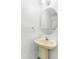 Bathroom with white pedestal sink, round mirror, and neutral decor at 524 Rider Ridge Dr, Longmont, CO 80504