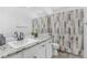 Modern bathroom featuring granite countertops, decorative mirrors, and stylish shower curtain at 524 Rider Ridge Dr, Longmont, CO 80504