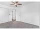Neutral bedroom with carpeted floor, ceiling fan, and white closets at 524 Rider Ridge Dr, Longmont, CO 80504