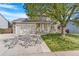 Attractive two-story home with stone accents, lush green lawn, and large shade tree at 524 Rider Ridge Dr, Longmont, CO 80504