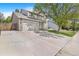 Charming two-story home boasts stone accents, a spacious driveway, and a well-maintained lawn at 524 Rider Ridge Dr, Longmont, CO 80504