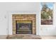 Fireplace with stone facade, white mantle and hearth and a window with outside view at 524 Rider Ridge Dr, Longmont, CO 80504