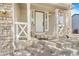 Welcoming front porch with white columns, stone accents and a charming welcome sign at 524 Rider Ridge Dr, Longmont, CO 80504
