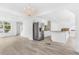 Open concept kitchen with stainless steel appliances, granite countertops, and light hardwood floors at 524 Rider Ridge Dr, Longmont, CO 80504