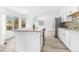 Modern kitchen with granite countertops, white cabinets, and stainless steel appliances at 524 Rider Ridge Dr, Longmont, CO 80504