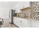 Beautiful kitchen with white cabinetry, granite counters, stainless appliances and mosaic backsplash at 524 Rider Ridge Dr, Longmont, CO 80504