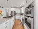 Modern white kitchen with stainless steel appliances, gas range, and granite countertops at 1140 S Sherman St, Denver, CO 80210