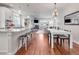Open-concept living room with a fireplace, dining area, and modern kitchen at 1140 S Sherman St, Denver, CO 80210