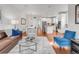 Open-concept living room flowing into the kitchen with hardwood floors and ample seating at 1140 S Sherman St, Denver, CO 80210