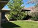 Well-maintained backyard with vibrant green lawn, mature trees, and patio at 1602 S Lamar St, Lakewood, CO 80232