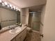 This bathroom features a vanity with a sink and a tiled shower at 1602 S Lamar St, Lakewood, CO 80232