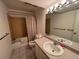 Well-lit bathroom features a vanity, toilet and tiled shower/tub combo at 1602 S Lamar St, Lakewood, CO 80232