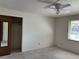 Bright bedroom with ceiling fan, closet, and window providing natural light at 1602 S Lamar St, Lakewood, CO 80232