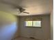 This is a simple bedroom featuring a ceiling fan and a window at 1602 S Lamar St, Lakewood, CO 80232