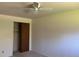 This bedroom features a ceiling fan and a closet with bi-fold doors at 1602 S Lamar St, Lakewood, CO 80232