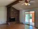 Inviting living room with brick fireplace, ceiling fan, and sliding doors to back area at 1602 S Lamar St, Lakewood, CO 80232